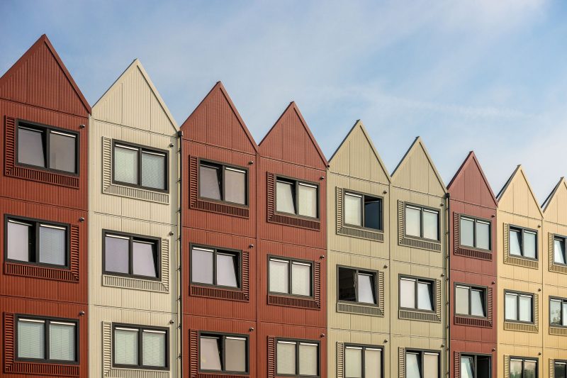 Home 14 A vibrant row of gableroofed residential buildings with meta 1782838821
