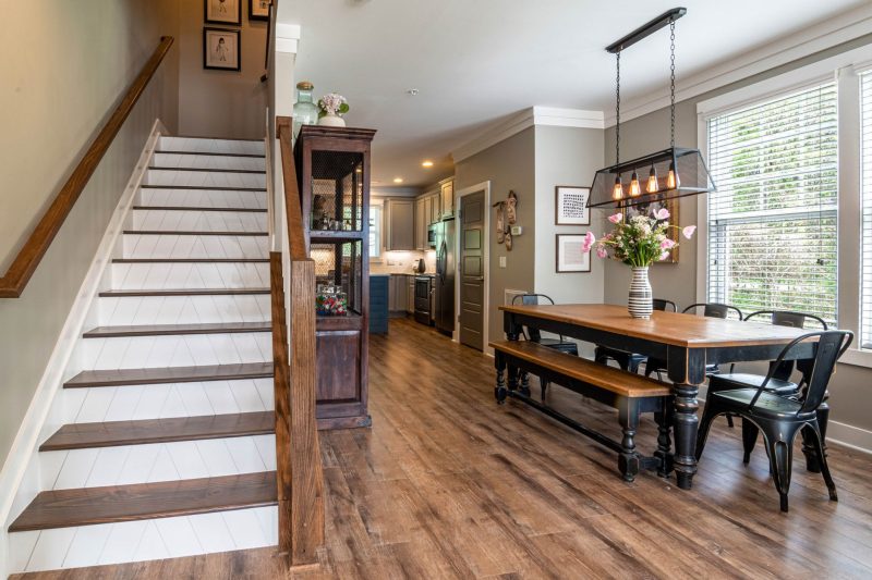 Home 12 Bright and inviting dining area features a wooden table stai 1784048529